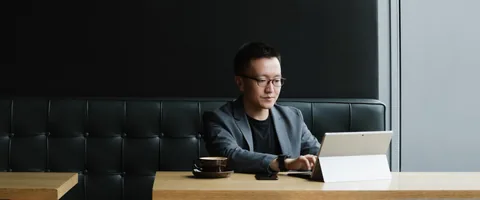 A person using a tablet at a cafe table.