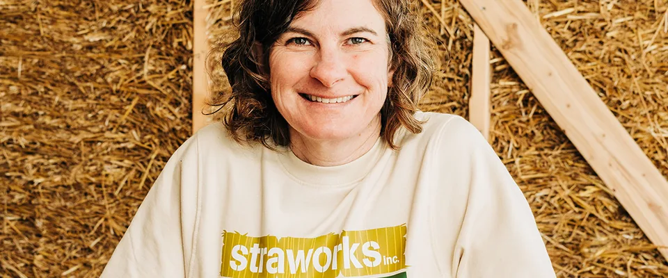 A small-business employee stands inside a building under construction.