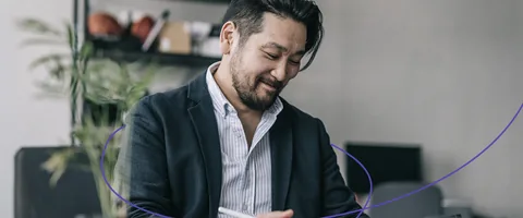 A person using a tablet at a desk.