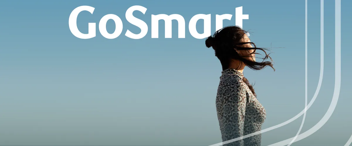 A person standing by the ocean beneath the GoSmart name.