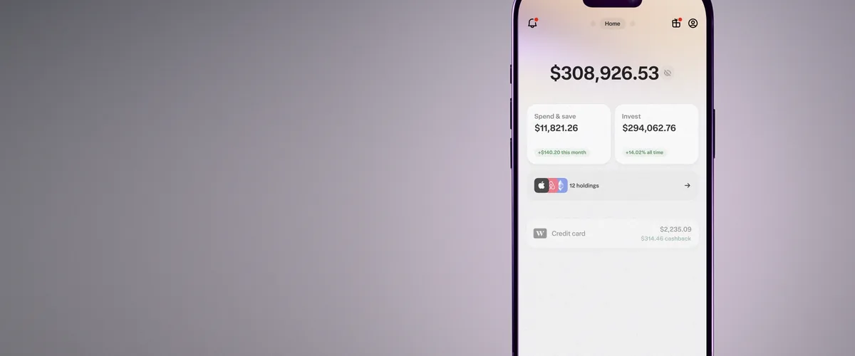 A phone displaying the Wealthsimple app's spending, saving, and investing overview.
